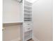 Walk-in closet with custom shelving, drawers and gold hardware at 1808 W Erna Dr, Tampa, FL 33603