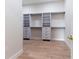 Walk-in closet features custom white shelving and drawers with hardwood floors at 1808 W Erna Dr, Tampa, FL 33603