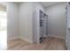 Spacious walk-in closet features white custom shelving with drawers at 1808 W Erna Dr, Tampa, FL 33603