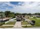 Aerial view of modern home with meticulously landscaped front yard and paved driveway at 1808 W Erna Dr, Tampa, FL 33603