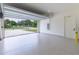 View of an open two car garage with epoxy flooring and view of the front yard at 1808 W Erna Dr, Tampa, FL 33603
