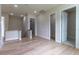 Open hallway with hardwood floors leading to various rooms and closets at 1808 W Erna Dr, Tampa, FL 33603