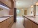 Modern kitchen with a white countertop island, wood cabinets, and stainless steel appliances at 1808 W Erna Dr, Tampa, FL 33603