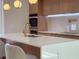 Modern kitchen with wood cabinets, white countertops, a gold faucet, and stainless steel appliances at 1808 W Erna Dr, Tampa, FL 33603