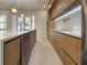 Modern kitchen featuring wood cabinets, stainless steel appliances, and a white countertop island at 1808 W Erna Dr, Tampa, FL 33603