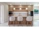 Modern kitchen featuring an island with seating and stainless steel appliances at 1808 W Erna Dr, Tampa, FL 33603
