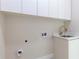 Bright laundry room features white cabinets, sink, and gold faucet at 1808 W Erna Dr, Tampa, FL 33603