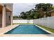 This inviting pool features water fountains, travertine surround, and a white fence, creating a tranquil outdoor space at 1808 W Erna Dr, Tampa, FL 33603