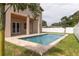 Beautiful pool features a tanning ledge, water features, and a spacious travertine surround perfect for relaxing at 1808 W Erna Dr, Tampa, FL 33603