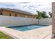 Inviting pool features fountains, travertine surround, white fence, and landscaping for an outdoor oasis at 1808 W Erna Dr, Tampa, FL 33603