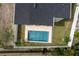 Aerial view of a backyard pool, surrounded by a well-maintained yard and privacy fence at 1808 W Erna Dr, Tampa, FL 33603