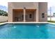 This enticing pool offers fountains and a built-in outdoor kitchen beneath the home's covered veranda at 1808 W Erna Dr, Tampa, FL 33603