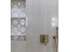 Close-up of the shower with built in shelving and decorative accent tile at 1808 W Erna Dr, Tampa, FL 33603