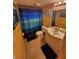 Bathroom featuring a vanity with ample countertop space, and a shower with a blue curtain at 1975 W Bay Dr # 304, Largo, FL 33770