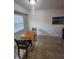 Bright dining area with a wooden table, chairs, and natural light from a window at 1975 W Bay Dr # 304, Largo, FL 33770