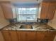 A close up on the kitchen counter with beautiful granite countertops and a stainless steel sink at 1975 W Bay Dr # 304, Largo, FL 33770