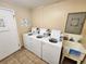 Laundry room featuring three washing machines and a utility sink at 1975 W Bay Dr # 304, Largo, FL 33770