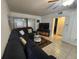 A spacious living room with sectional sofa, TV, sliding glass door, and a neutral color scheme at 1975 W Bay Dr # 304, Largo, FL 33770