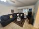 Cozy living room features a comfy sectional, stylish coffee table, and sliding glass doors at 1975 W Bay Dr # 304, Largo, FL 33770
