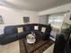 Comfortable living room with a sectional sofa, decorative pillows, and sliding glass door at 1975 W Bay Dr # 304, Largo, FL 33770
