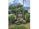 Entrance sign for Belleair Oaks Condominiums at 1975 West Bay Drive beneath an American flag at 1975 W Bay Dr # 304, Largo, FL 33770