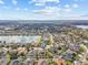 Aerial view of home in residential neighborhood with lake and lush surroundings at 22623 Cliffside Way, Land O Lakes, FL 34639