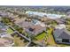 Aerial view of the home, fenced yard and pool in a community with a lake at 22623 Cliffside Way, Land O Lakes, FL 34639