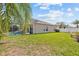 Backyard with manicured lawn leading up to screened lanai at 22623 Cliffside Way, Land O Lakes, FL 34639