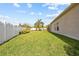 Grassy backyard with privacy fence and view of side of house at 22623 Cliffside Way, Land O Lakes, FL 34639