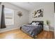 Bedroom with wood floors, large window, and decorative wall art at 22623 Cliffside Way, Land O Lakes, FL 34639