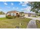Charming home with lush lawn, manicured garden, and a welcoming walkway, perfect for Gathering living at 22623 Cliffside Way, Land O Lakes, FL 34639