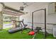 Garage converted to home gym with turf flooring and full exercise equipment at 22623 Cliffside Way, Land O Lakes, FL 34639