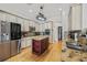 Bright kitchen featuring stainless steel appliances, center island, and granite countertops, ideal for cooking enthusiasts at 22623 Cliffside Way, Land O Lakes, FL 34639