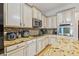 Well-appointed kitchen featuring stainless steel appliances, granite countertops, and tiled backsplash for a sleek look at 22623 Cliffside Way, Land O Lakes, FL 34639