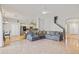 Spacious living room with tile floors, gray sofas, and an open floor plan to the kitchen at 22623 Cliffside Way, Land O Lakes, FL 34639
