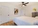 Spacious bedroom with white walls, wood-look floors, ceiling fan, and a dresser at 2311 16Th S Ave, St Petersburg, FL 33712