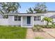 Charming front entrance with a blue door, manicured plants, and a walkway to the driveway at 2311 16Th S Ave, St Petersburg, FL 33712