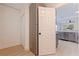 Hallway view of the kitchen featuring stainless steel refrigerator and wood-look flooring at 2311 16Th S Ave, St Petersburg, FL 33712