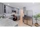 Modern kitchen with stainless steel appliances, gray cabinetry, and a view to the dining area at 2311 16Th S Ave, St Petersburg, FL 33712