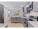 Modern kitchen features gray cabinets, stainless steel appliances, and granite countertops at 2311 16Th S Ave, St Petersburg, FL 33712
