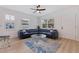 Bright and airy living room featuring luxury vinyl flooring, a new fan, and a comfortable blue sectional at 2311 16Th S Ave, St Petersburg, FL 33712