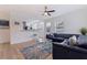 Inviting living room with a blue leather sofa, modern fan, and open floor plan to the kitchen at 2311 16Th S Ave, St Petersburg, FL 33712