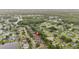 An aerial view displays the home's location within a tranquil neighborhood with mature trees at 3725 Grand Forks Dr, Land O Lakes, FL 34639