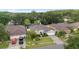 Aerial view showcasing the well-maintained home, lush landscaping, and spacious driveway at 3725 Grand Forks Dr, Land O Lakes, FL 34639