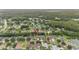 Aerial view shows property location in a lush, green, suburban neighborhood near a pond at 3725 Grand Forks Dr, Land O Lakes, FL 34639