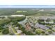 Aerial view of a neighborhood featuring lush landscaping, mature trees and ponds at 3725 Grand Forks Dr, Land O Lakes, FL 34639