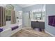 This bright bathroom features a separate shower and tub, dual vanity and wood look floors at 3725 Grand Forks Dr, Land O Lakes, FL 34639