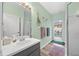 Light and airy bathroom featuring a modern vanity and an open shower, plus access to the pool area at 3725 Grand Forks Dr, Land O Lakes, FL 34639