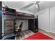 Bedroom with a unique lofted bed setup with desk and chair underneath, and a cozy red carpet at 3725 Grand Forks Dr, Land O Lakes, FL 34639
