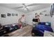 Fun ' bedroom with two beds, desks, wood-look floors, and space-themed decor at 3725 Grand Forks Dr, Land O Lakes, FL 34639